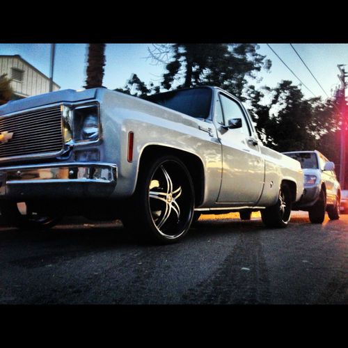 78 silver paint with black sprayed rhino type bedliner 22s staggered wheels